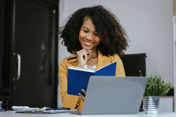 istock Female writes information businessman working on laptop computer writing business plan while sitting in office. 2155488455