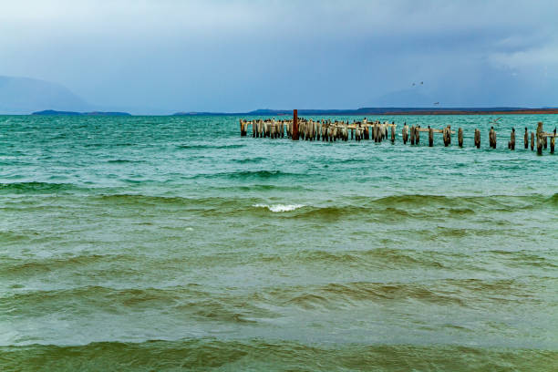 Ruins of the pier. Strait of Magellan. Punta Arenas is the southernmost city on the Brunswick Peninsula. South America. Chile.