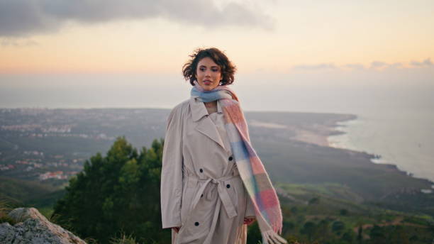istock Elegant model posing sunset sky expressing serene beauty. Curly woman on coast 2155489746
