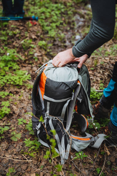 istock a person is opening a backpack in the woods 2155492953
