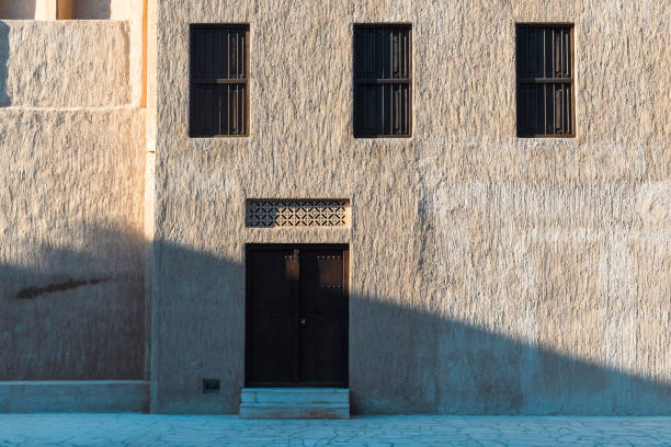 Dubai, UAE - January 6, 2024: The intricate patterns of a traditional Emirati building stand out in the heart of Dubai, a testament to the cityâs cultural roots.