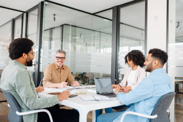 istock Colleagues engage in a lively exchange of ideas in an office 2155493358