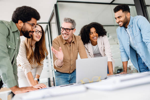 istock Colleagues engage in a lively exchange of ideas in an office 2155493385
