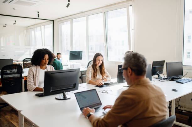 A team of professionals works diligently in a bright, open office space.