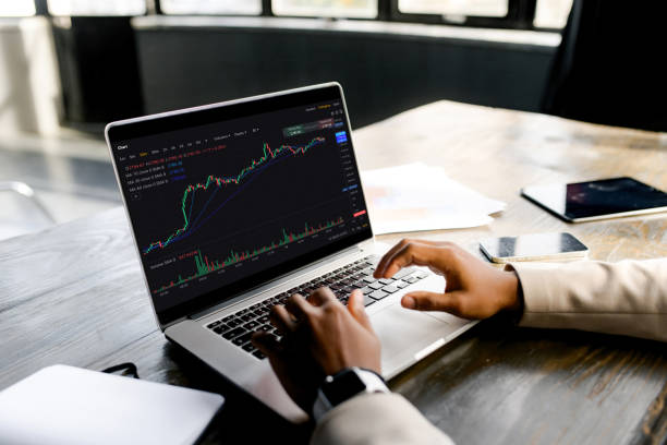 istock Businessman trader analyzes financial charts on laptop 2155493479