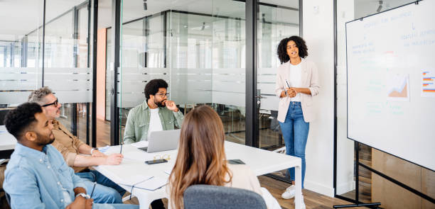 istock Colleagues engage in a lively exchange of ideas in an office 2155493569