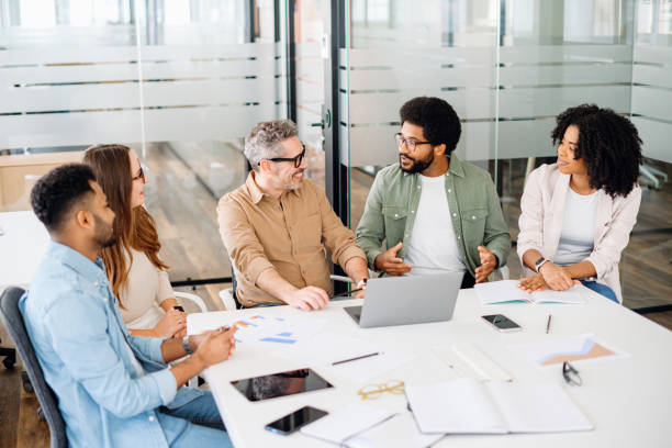 istock A diverse group of colleagues enjoys a shared joke, creating a relaxed and friendly atmosphere 2155493903