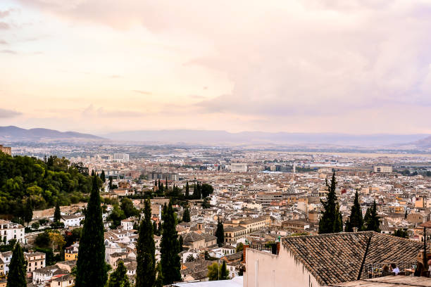 Barcelona skyline at sunset with warm light over city rooftops.