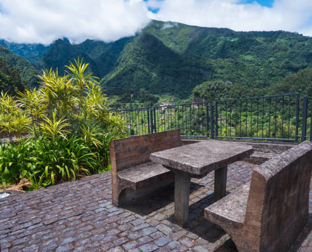concrete bench and table with beautiful view on green hills and valley from resting place, viewpoint at Sao Roque do Faial Santana , Madeira Island, north coast