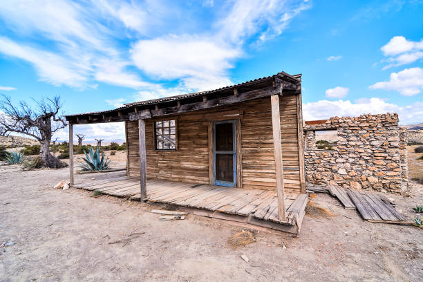 istock A small, old house with a porch and a door 2155497615