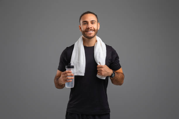 istock Smiling man with towel and water bottle 2155498289