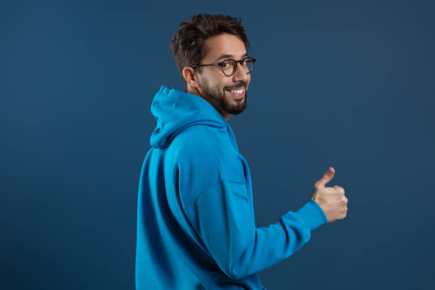 istock Happy Young Man Turning At Camera And Showing Thumb Up 2155498485