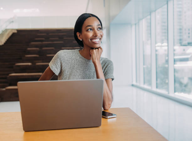istock Smiling Woman Working On Laptop In Modern Office 2155498706