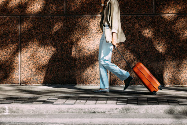 istock Traveler Walking with Suitcase on Urban Sidewalk 2155498717