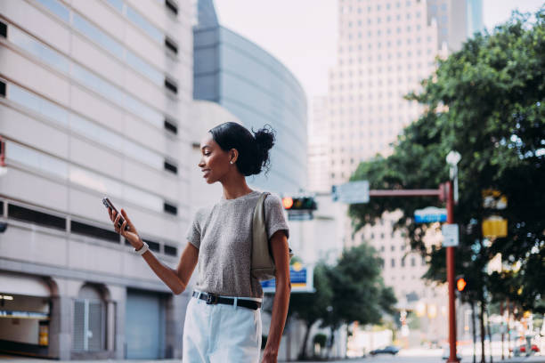 Smiling Woman Using Smartphone in a Busy Urban Area