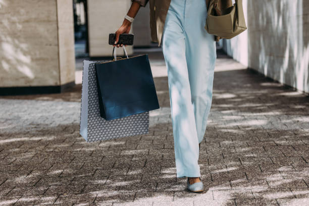 istock Woman Shopping Outdoors Holding Bags During Daytime 2155498768