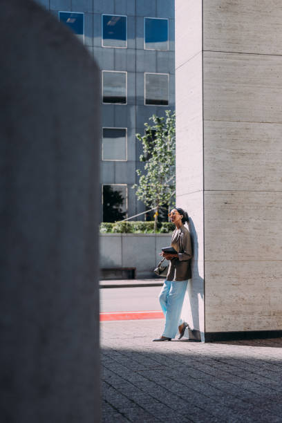 istock Businesswoman Standing Outside Office Building Holding Digital Tablet 2155498772