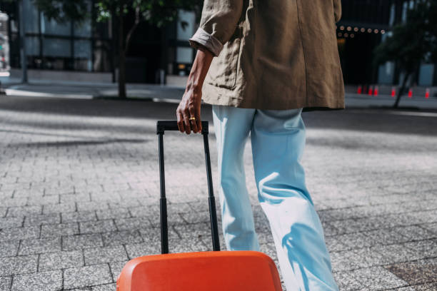 istock Person Walking with Suitcase on City Street 2155498779