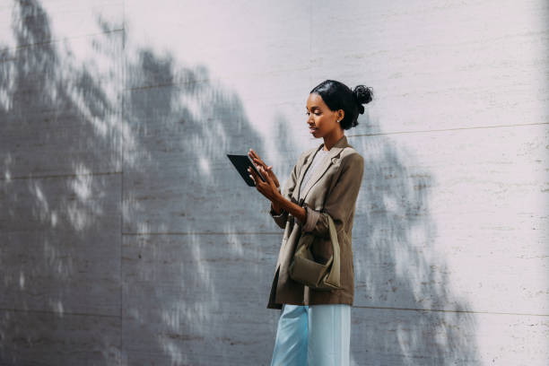 istock Businesswoman Working Outside With Tablet Under Tree Shadow 2155498780