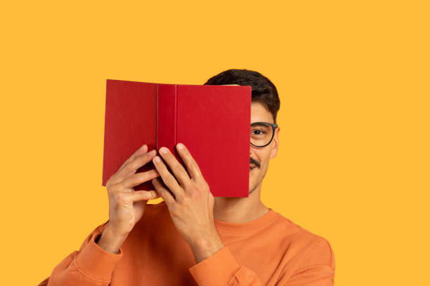 istock Man with moustache covering face with a book 2155498825