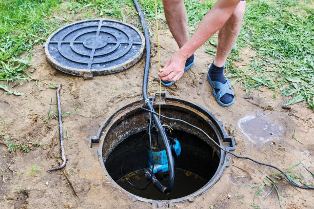 istock Maintenance of rural sewerage, pumping out sewage using a submersible wastewater pump. 2155498897