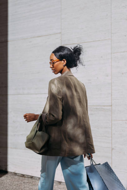 istock Elegant Woman Shopping Outdoors On Sunny Day 2155498911