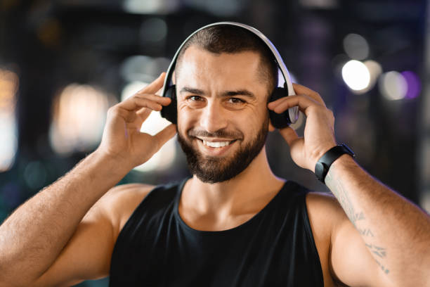 istock Athletic Man With a Beard Wearing Headphones 2155499160