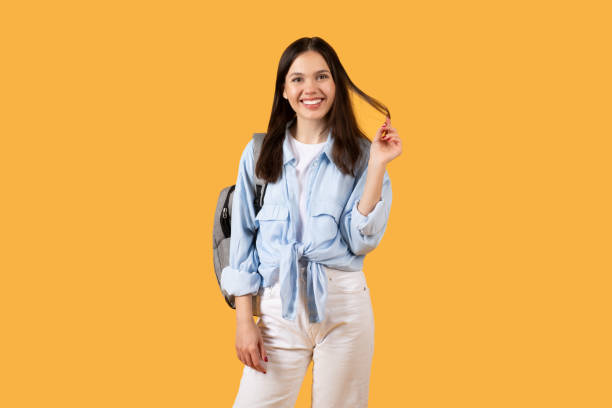 istock Confident lady student with casual style, carrying backpack and ready for day at college 2155499984