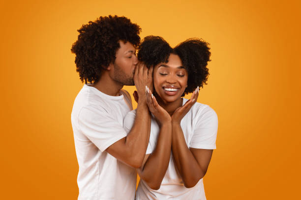 istock Black guy whispering something on his girlfriend ear 2155500400