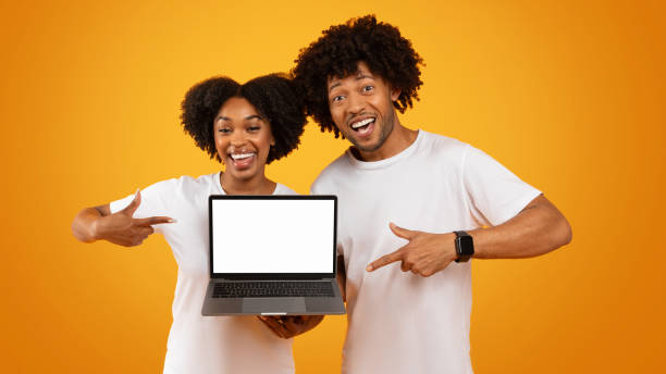 istock Positive millennial black couple holding laptop with blank screen 2155500415