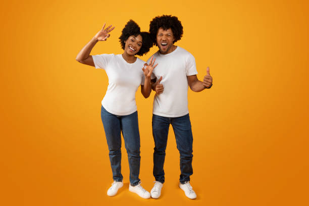 istock Cool african american man and woman gesturing on yellow background 2155500519