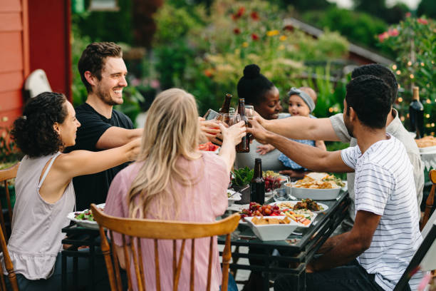 istock Group of friends cheers while eating meal outside 2155500712