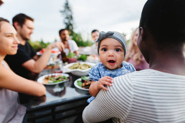 istock Cute baby makes silly face while outside with family 2155500731