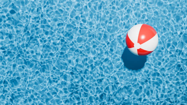 istock Summer holidays banner. Swimming pool top view. Beach ball in the empty clear pool. 2155502285