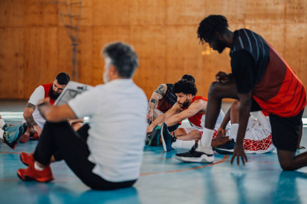 istock Hispanic basketball player stretching before match or training in a sports hall 2155502429