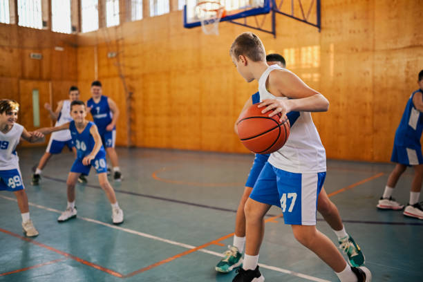 istock Junior basketball team in action playing basket at training. 2155502447
