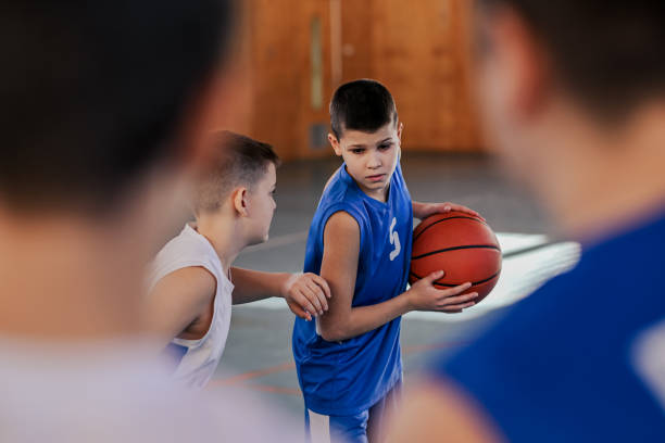 istock A junior basketball player is keeping the ball on basketball training. 2155502448