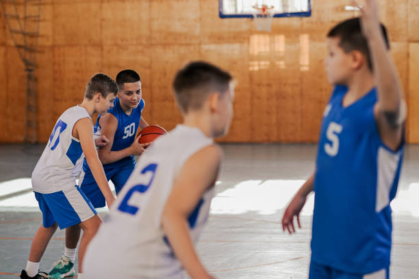 istock Junior basketball team in action is practicing basketball game playing 2155502469