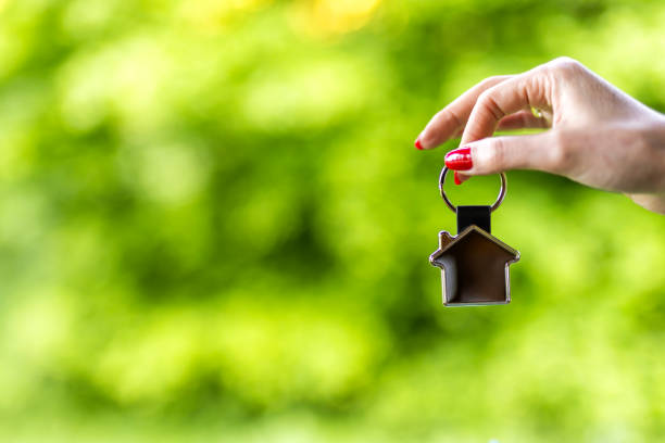 Real estate concept with home keys in hand
