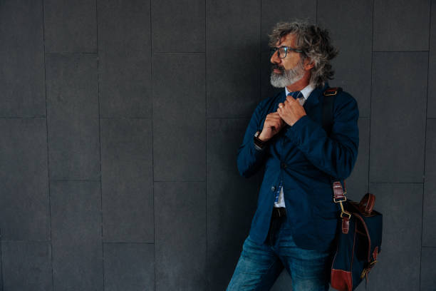 istock Mature businessperson on dark background with copy-space 2155503110