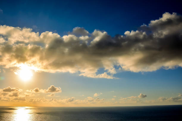 The sky is blue with a few clouds and the sun is shining, image