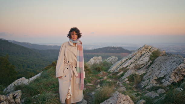 istock Woman walking evening hills at tranquil weekend. Elegant lady exploring nature 2155505770
