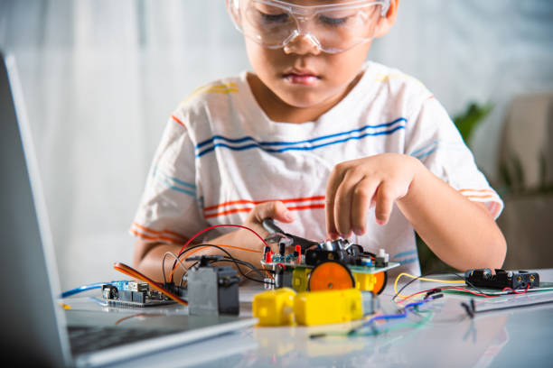 istock Asian kid boy assembling the A.I. robot car homework project at home 2155510536