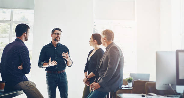 istock Business, people and meeting for discussion in office by networking, presentation and training with leader as web design. Man, staff and mentor for communication, teamwork and ideas for project 2155511509