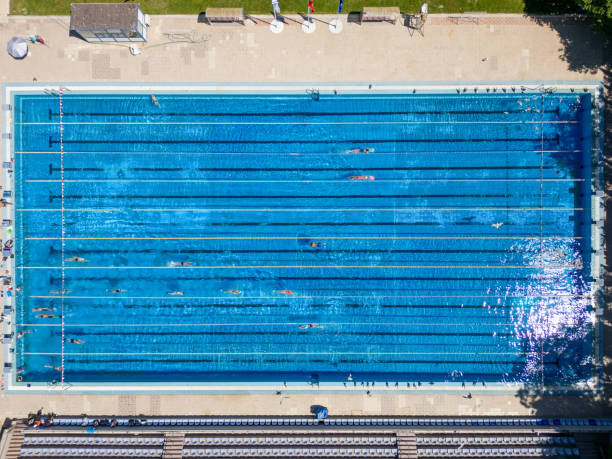 istock group of swimmers training in an outdoor pool top down view 2155511834