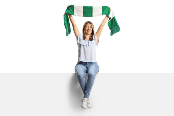 istock Happy young woman sitting on a blank panel and holding a scarf 2155511892