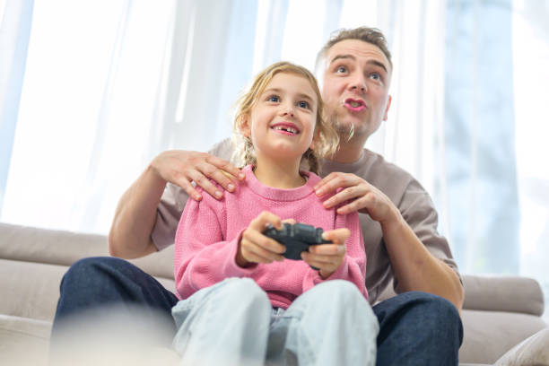 istock Family Gaming Time: Father Teaches Daughter Video Game Tricks 2155511962