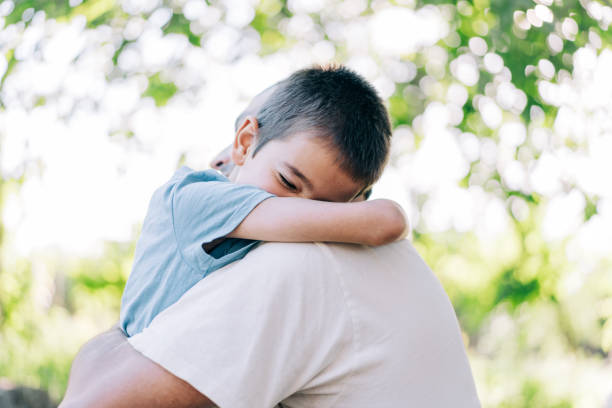istock Father and son hugging outdoors. 2155513885