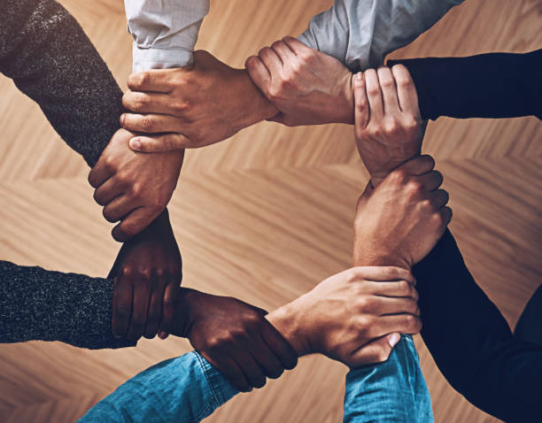 istock Solidarity, holding or hands of business people with diversity for group support or teamwork in office. Community, link or above group of employees with mission or team building for goals together 2155514028
