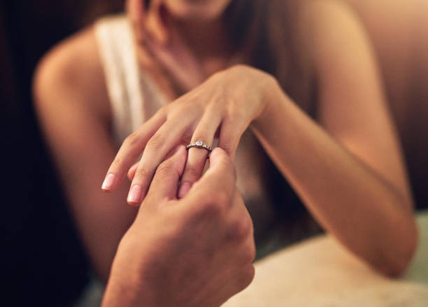 istock Engagement, proposal and couple hands with ring in restaurant for celebration, wedding and marriage. Love, happy and man and woman with diamond jewelry on finger for date, commitment and romance 2155514230